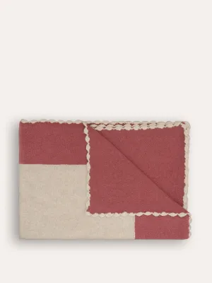 Pink bordered knitted throw
