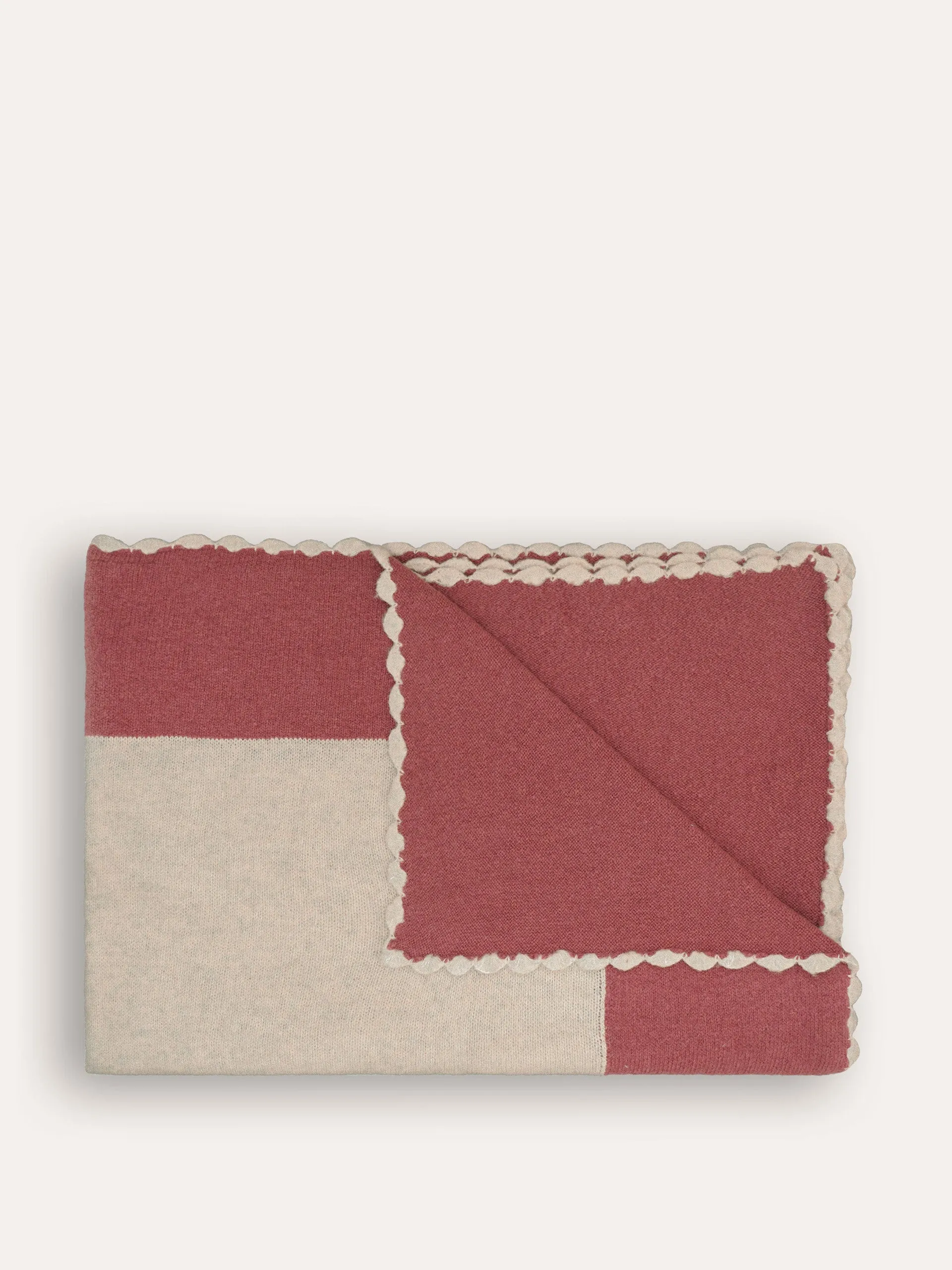 Pink bordered knitted throw