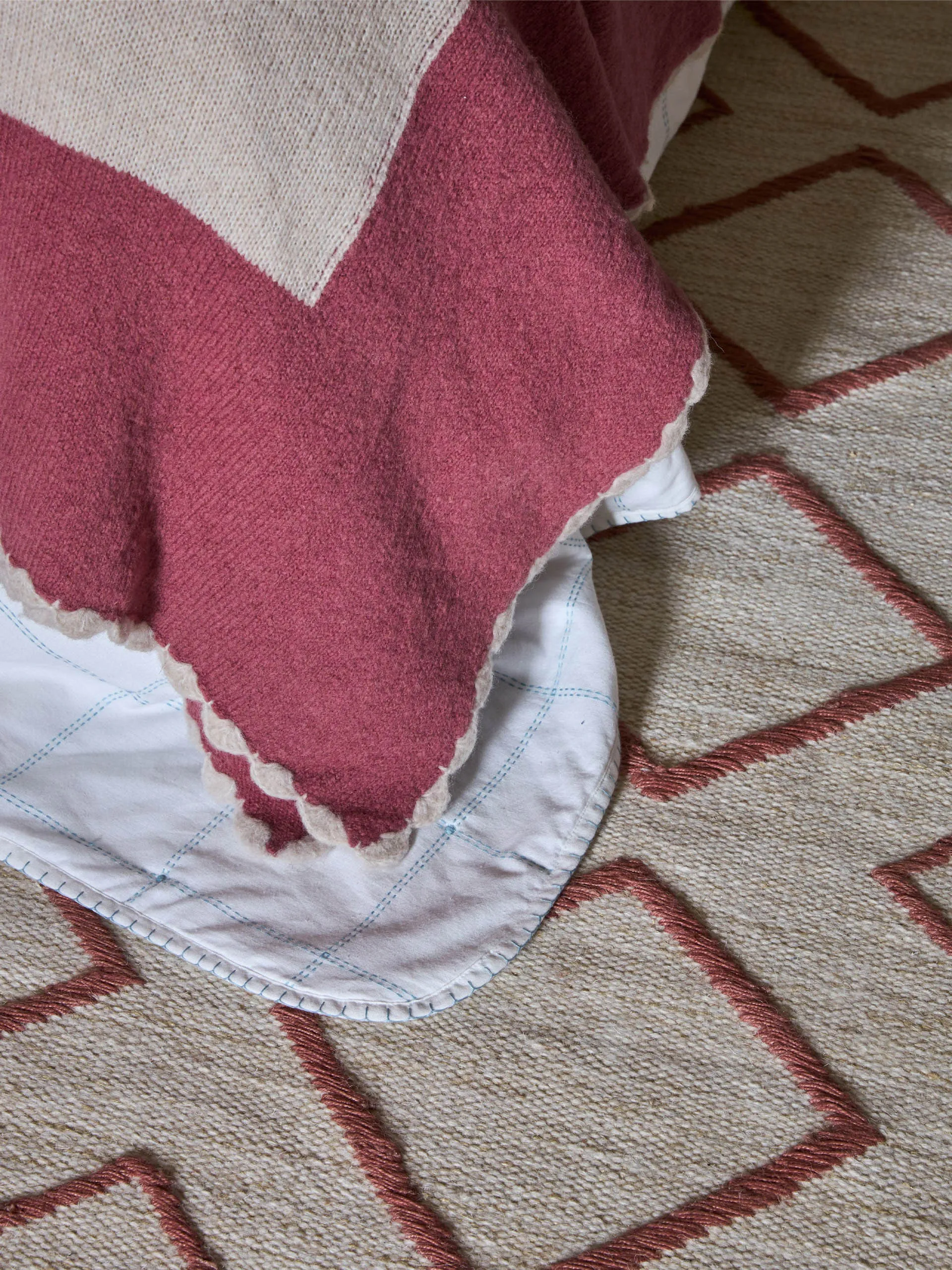 Pink bordered knitted throw